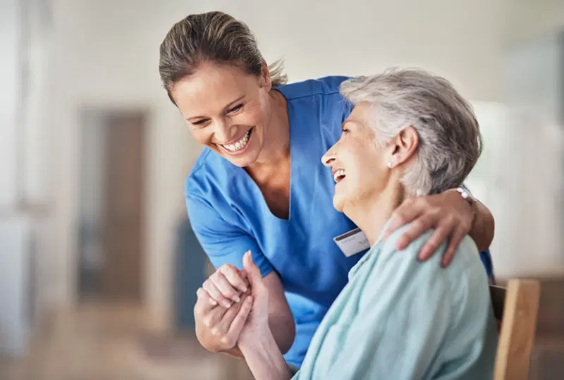 happy caregiver with senior lady